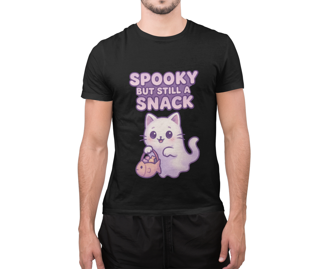 Model wearing a black T-shirt featuring a purple ghost cat holding a candy bag with Spooky but Still a Snack lettering.