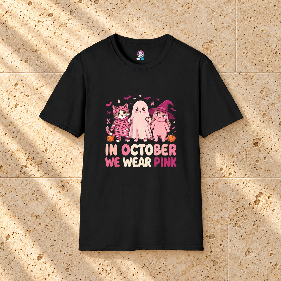 In October We Wear Pink Cats T-Shirt — black shirt on warm beige travertine