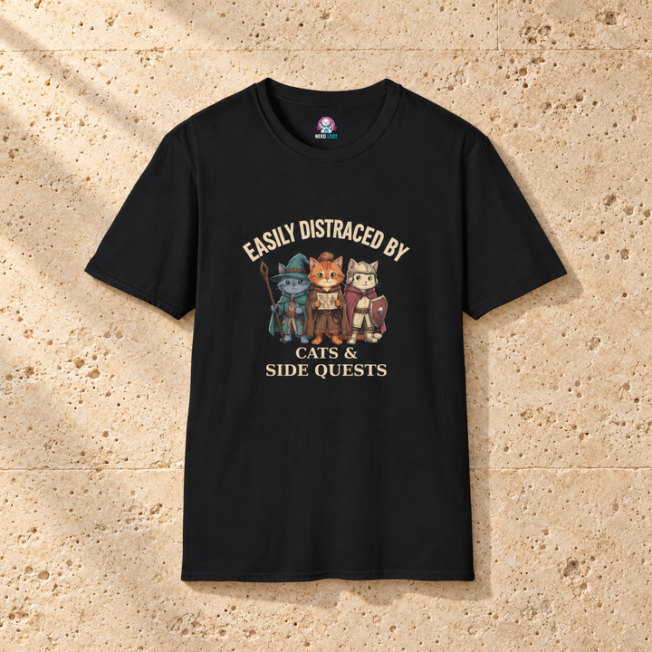 Easily Distracted by Cats and Side Quests T-Shirt — black shirt on warm beige travertine