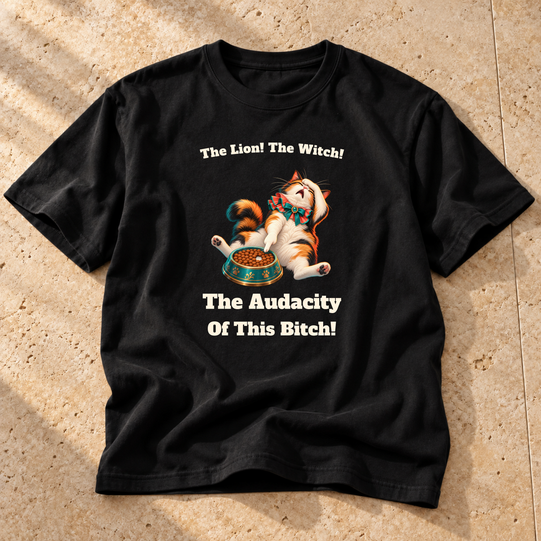 Black Tiny Inconvenience Cat T-Shirt on warm travertine stone.