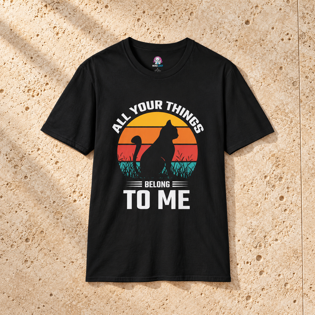 Black All Your Things Funny Cat T-Shirt on warm travertine stone.