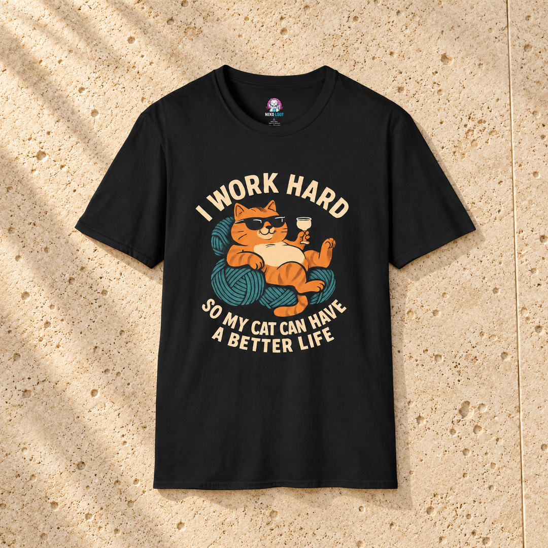 Black Work Hard Cat T-Shirt on warm travertine stone.